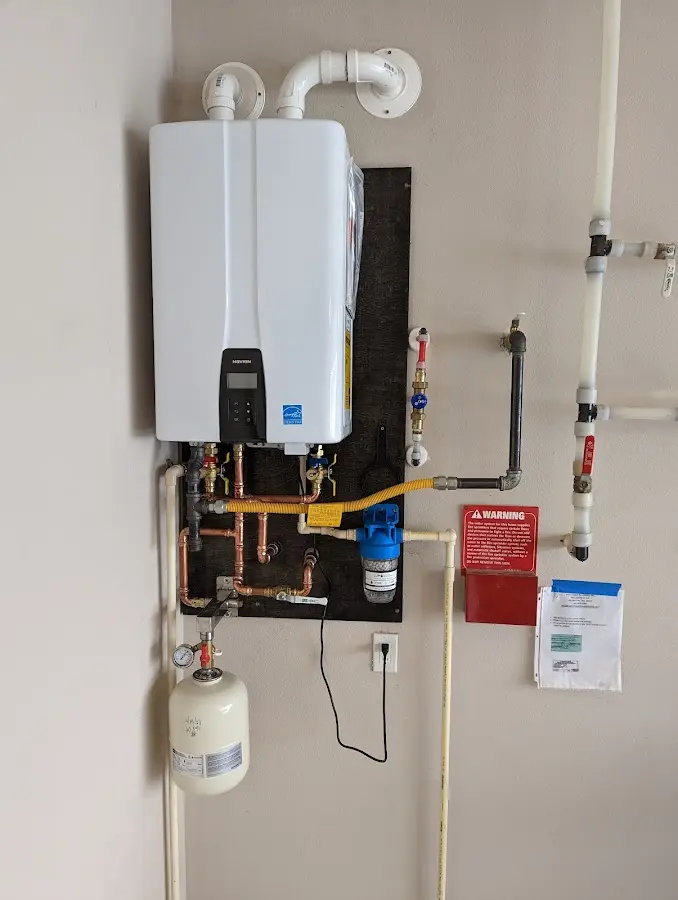 Professional plumber installing copper piping in a Westtown home